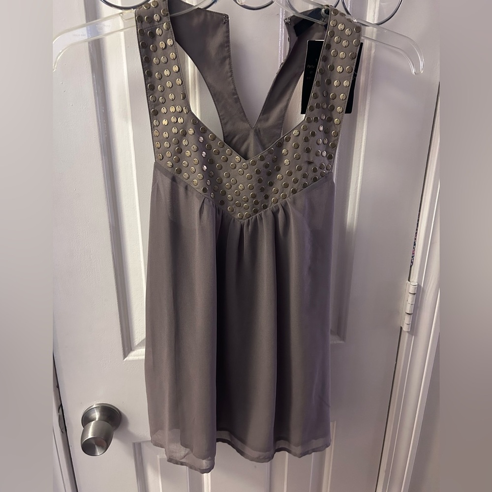 Ladies xsmall  NWT- has gold circle studs on front and back